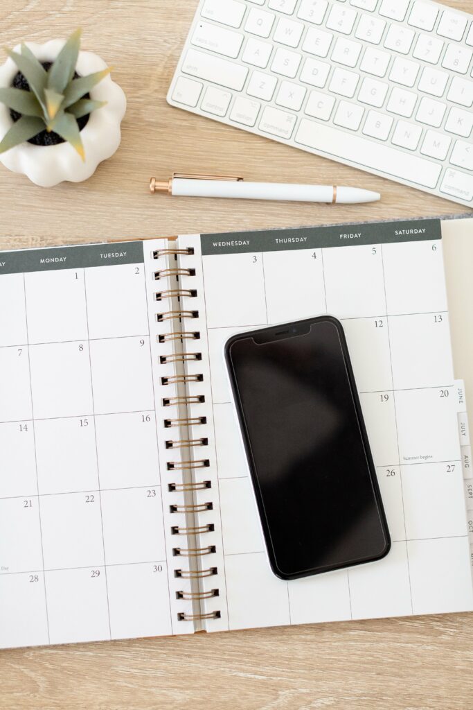 Calendar and phone used to book photography clients